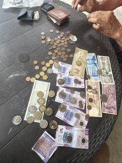 lot of coins different years some are US coins some are pesos