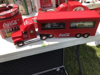 Coca Cola truck with cars in trailer