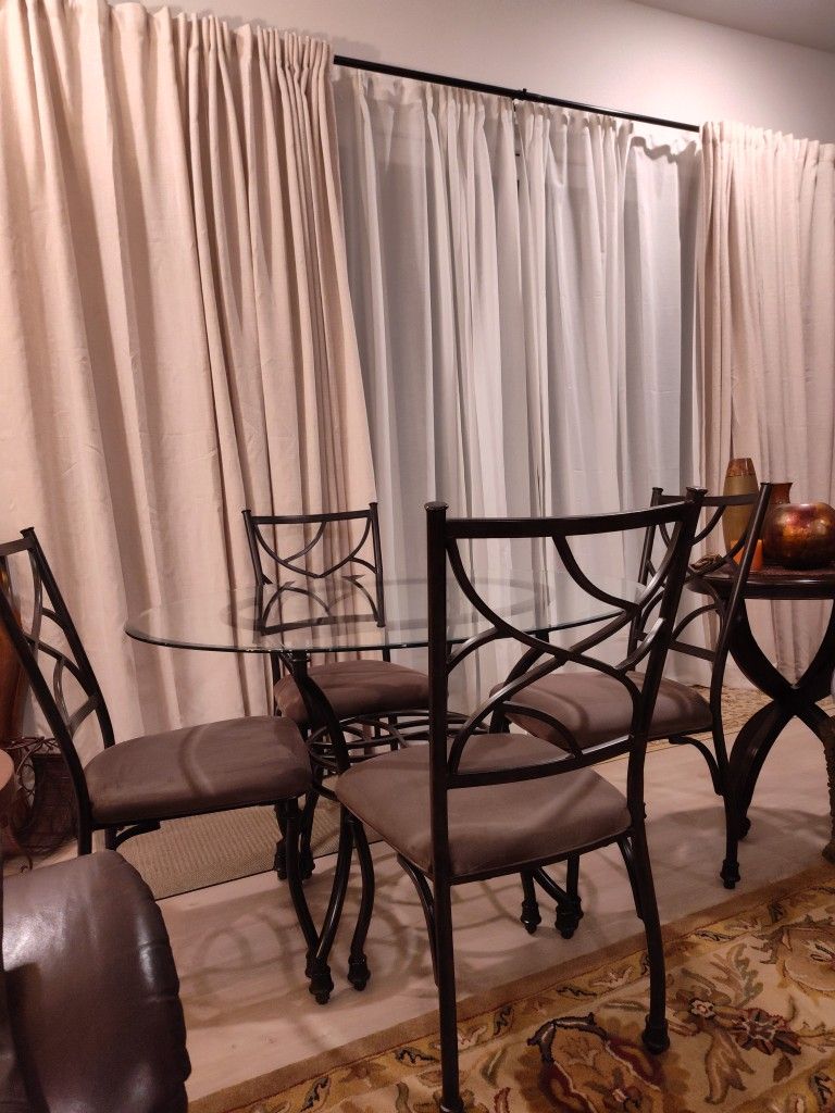 Beautiful Vintage Ashley Furniture Industries Inc Bevelled Round Glass Table With Iron Base And Four Beige/Taupe Cushion Iron ChairsI