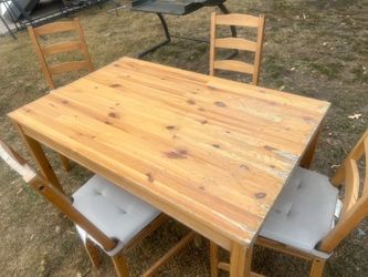 Dining table set with four chairs and cushion