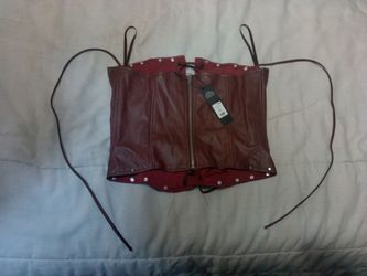 A Fashion Nova Sienna Burgundy Faux Leather Corset Top.