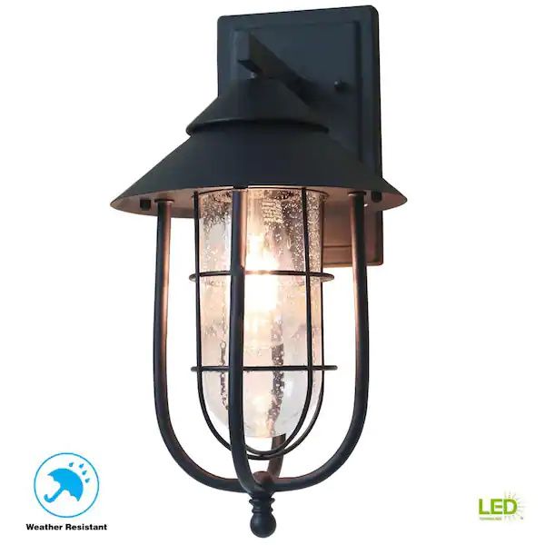 Wisteria Collection 1-Light Sand Black Outdoor Wall Lantern Sconce with Clear Glass Shade  Dimensions: H 13.75 in, W 7.25 in, D 8.5 in   