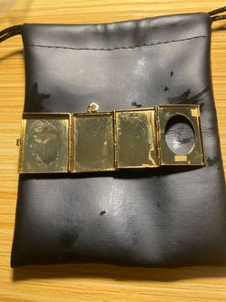 Gold tone book-shaped photo locket pendant, heavily popularized by Avon and other costume jewelry makers primarily around the 1970s and 1980