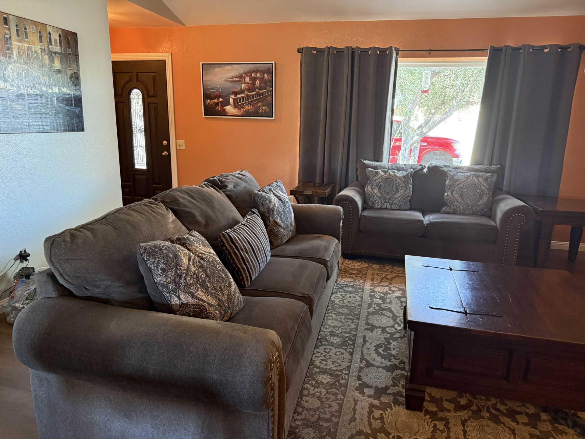 Ashley Charcoal Chenille Fabrics Sofa and Loveseat set with rolled arms and nailhead trim