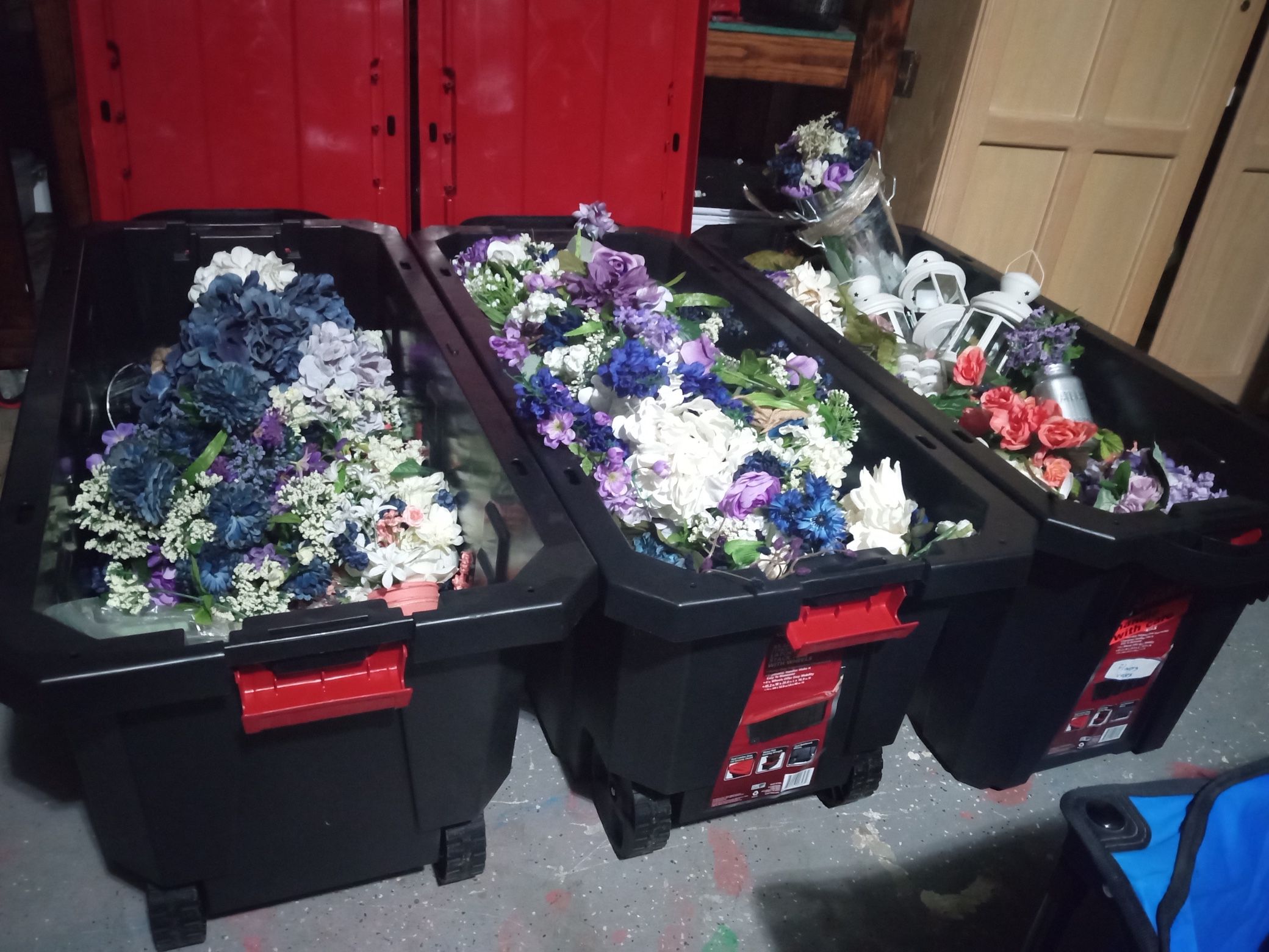 Several Huge Bins On Wheels Of Wedding Decor 