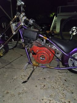 Selling my custom mini chopper project exactly as it sits. Features a stretched rigid frame, long front fork setup, wide cruiser wheels, and a torque