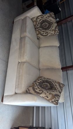 Cream sofa with 2 accent pillows
