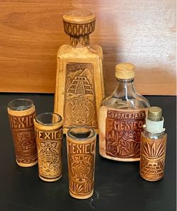 Hand carved leather liquor bottles and shot glasses