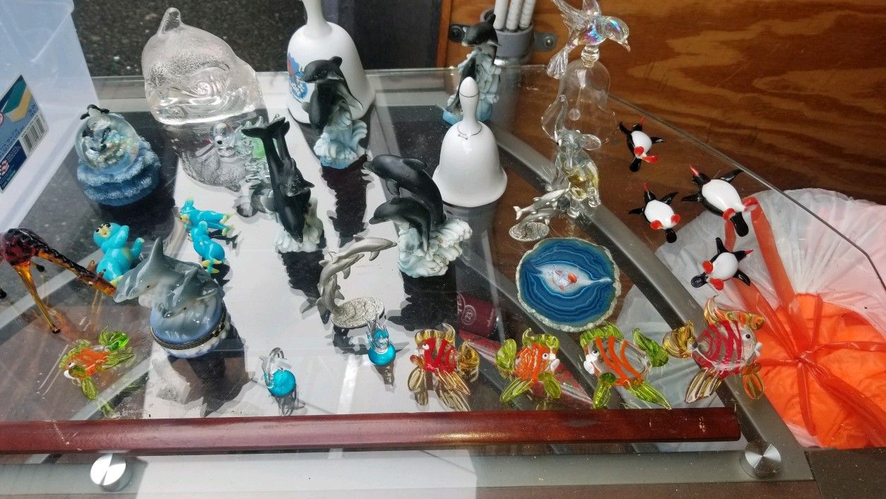 Decorative glass figurines and bells and dolphins