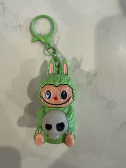 Labubu holding a skull keychain holographic green