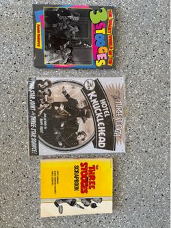 Three Stooges books and metal hanging Art