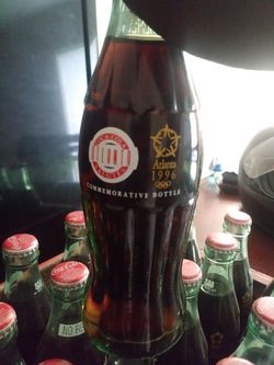 1996 Olympic Coca-Cola bottles and coca cola create dated in 1977.