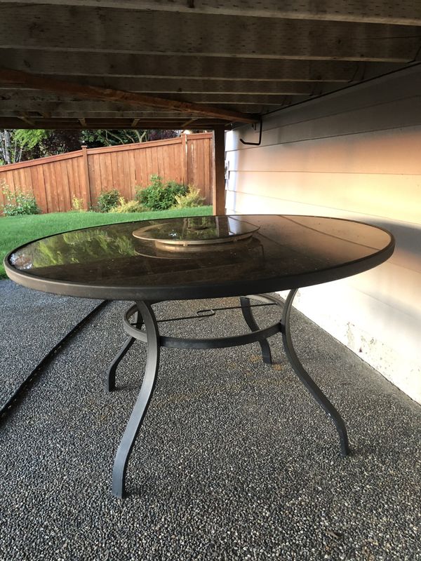 50” round outdoor patio table only, no chairs. Lazy Susan in the middle