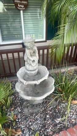4 foot high water fountain made out of concrete