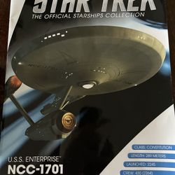 A  Model Of USS Enterprise With The Book 