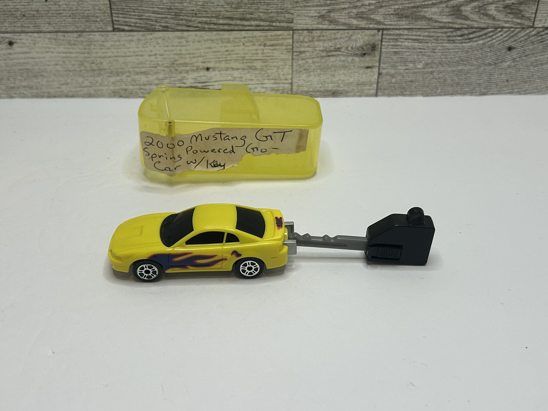 Vintage BKC IRWN Toy Yellow ‘2000 Ford Mustang GT / Spring Powered Go With Key • Plastic Car and Key • Made in China