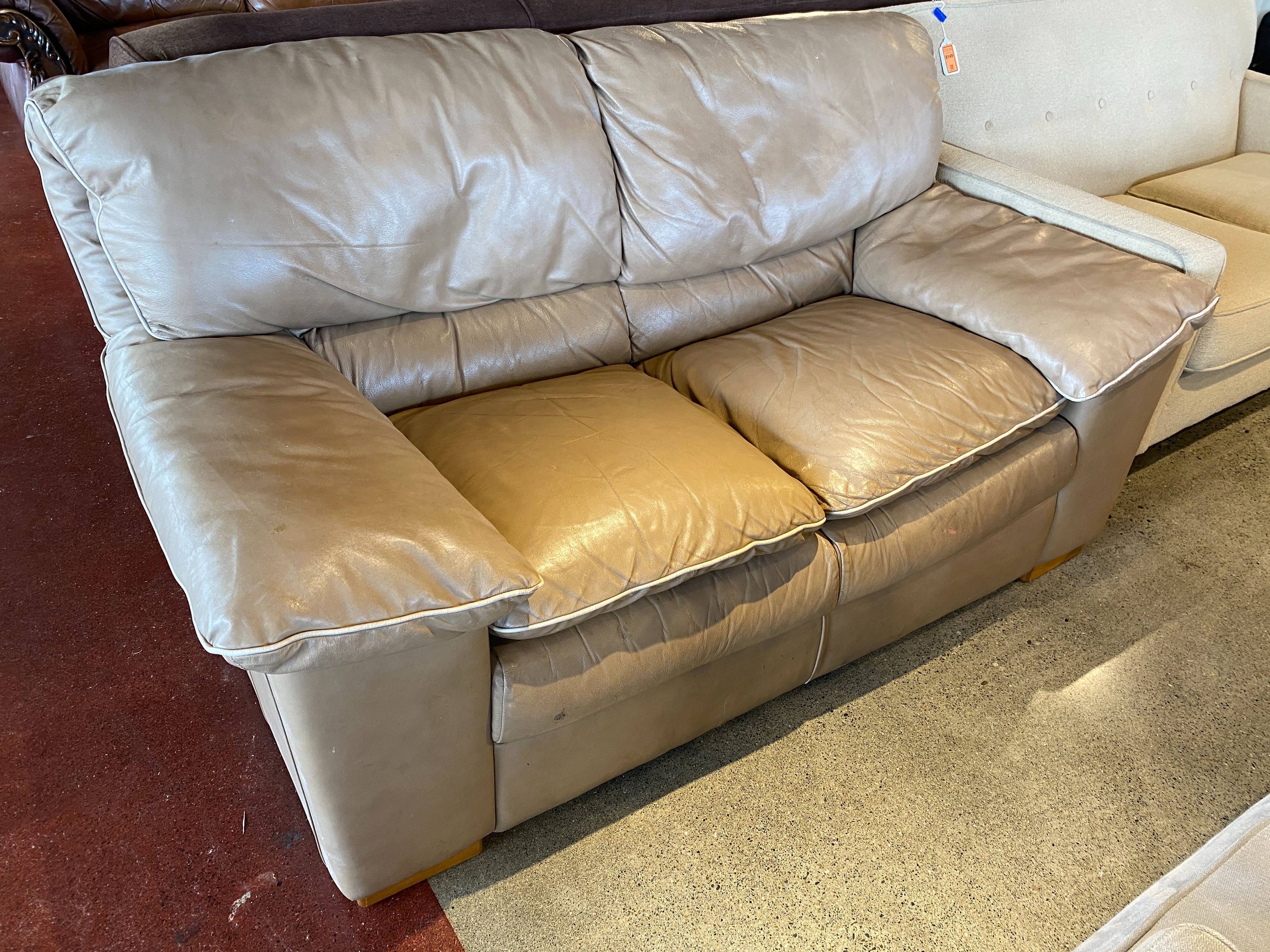 Neutral Colored Leather Loveseat with White Piping