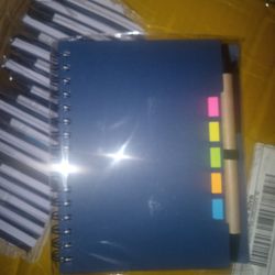Small notebook with sticky notes and pen