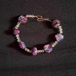 The object in thandmade lampwork glass lentil-shaped bead bracelet