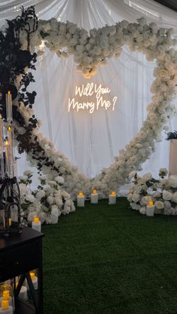 White heart shaped arch backdrop proposal wedding