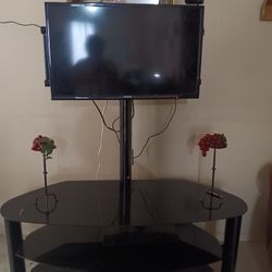 28 inch TV with glass table and holder. 