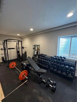 Home Gym Setup with Rack, Bench, and Dumbbells