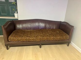 Brown Leather Sofa with Leopard Print Cushion