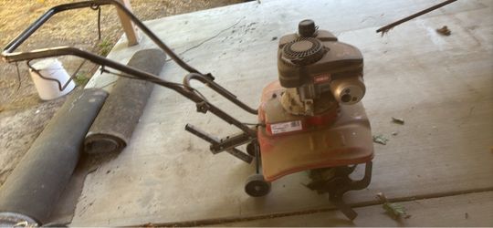 Troy-Bilt-style tiller with a gasoline engine.