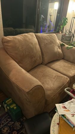 A sofa loveseat and a table