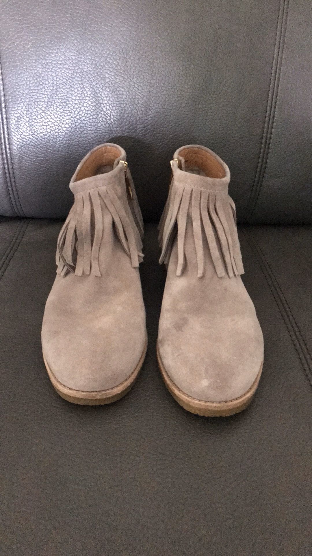 DETAILS Fringe surrounds the low shaft of these suede Kate Spade New York booties. Exposed side zip. Textured rubber sidewall and sole. Leather: Co