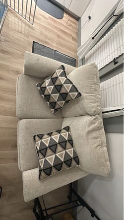 Beige Upholstered Loveseat with Decorative Throw Pillows