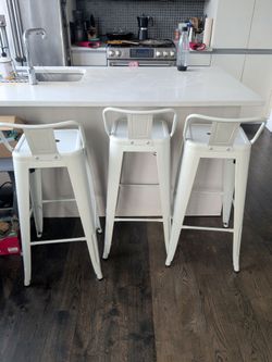Desks, chairs, end tables, bookshelves, plants, couch, coffee table