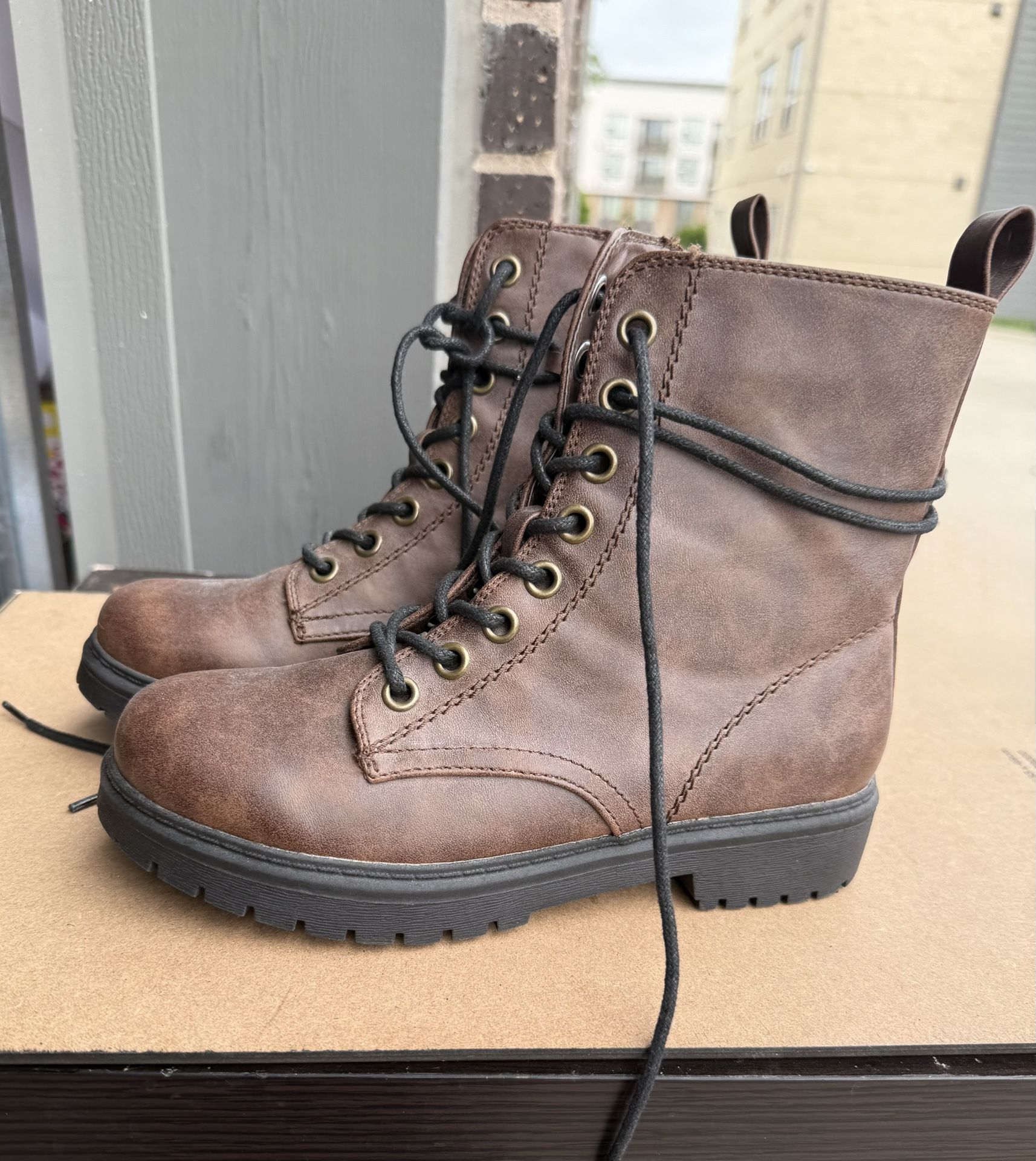 Combat boots with studded soles, laces, and side zipper