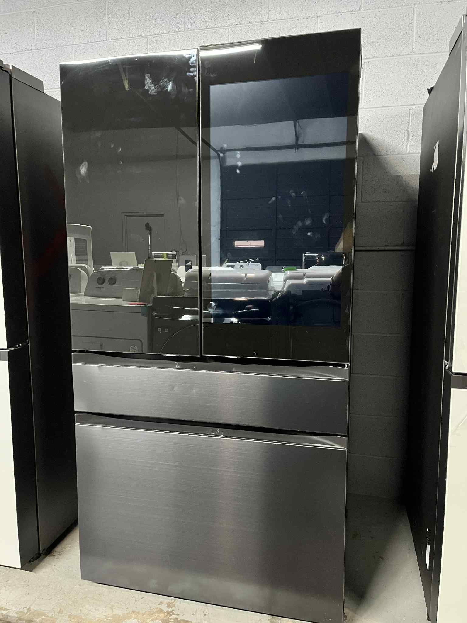 Samsung refrigerator 29  cu. ft with large family hub in Black glass and stainless steel Panels.