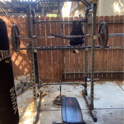 Squat Rack With 3 Pairs Of 45pounds And I Pair Of 35 One Pair Of 25 And 2 Pairs Of 10 