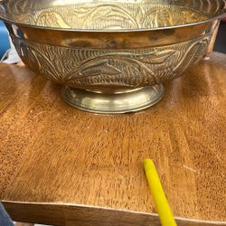 This is a vintage brass bowl, possibly from India, with a decorative design on the exterior. The image shows the underside of the bowl, which has a st
