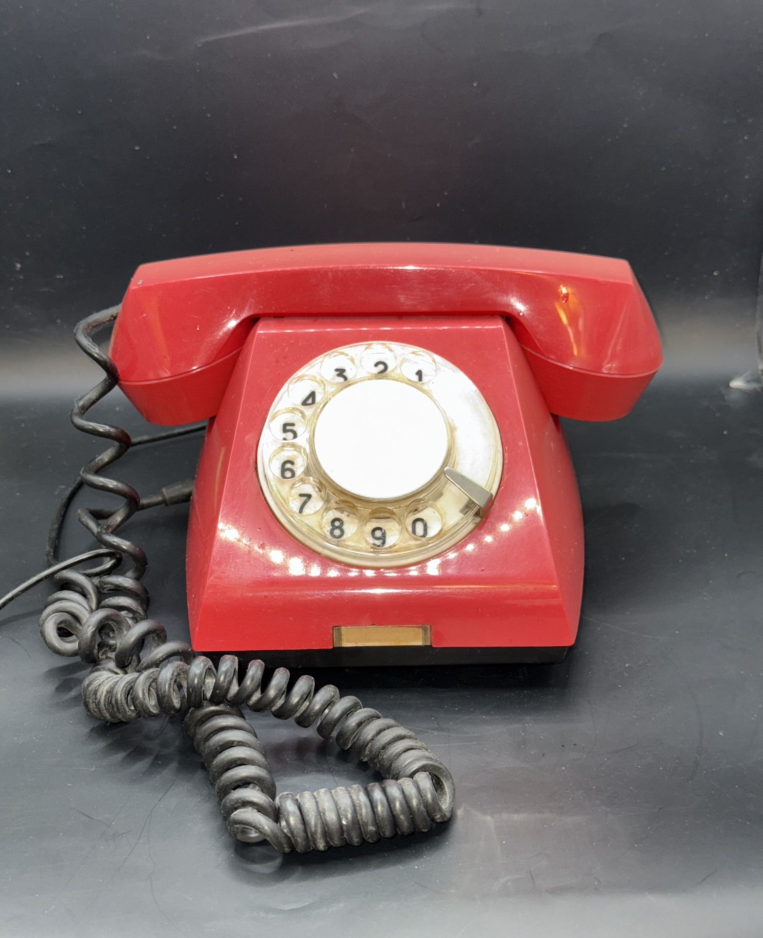 retro rotary phone manufactured by Tesla in the 1980s, featuring a distinctive red color. This vintage telephone hails from Slovakia