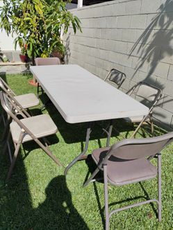 7 ' table and 6 cushion chairs