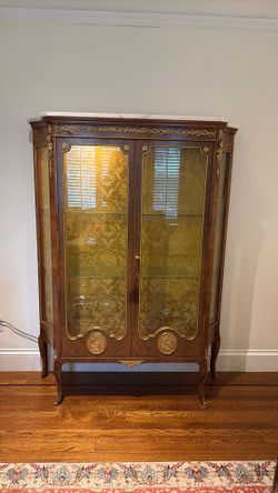 Wooden cabinet with gold metal with inside light