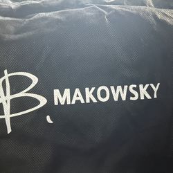 B. Makowsky purse The handle and strap are made of leather.