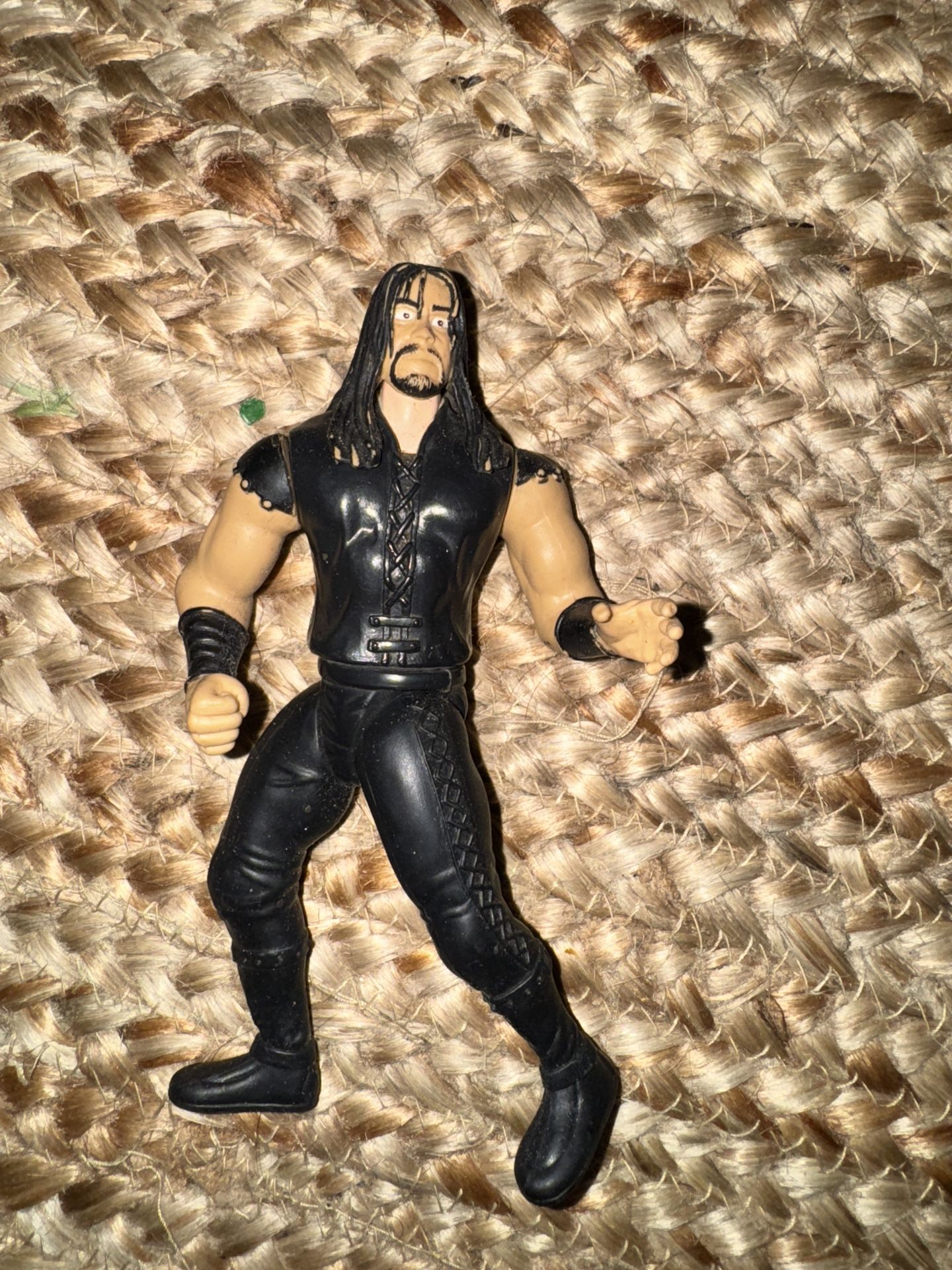 The Vintage 1997 WWE THE UNDERTAKER Jakks Pacific Slammers Wrestling Action Figure is a 6-inch plastic collectible representing the iconic WWE charact