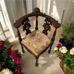Antique Mahogany figural carved corner chair, often referred to as a "roundabout" chair. Similar antique or vintage pieces often feature ornate detail