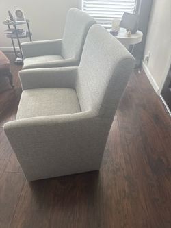 Two grey arm chairs