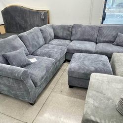 Round arms Gray corduroy sectional sofa with ottoman