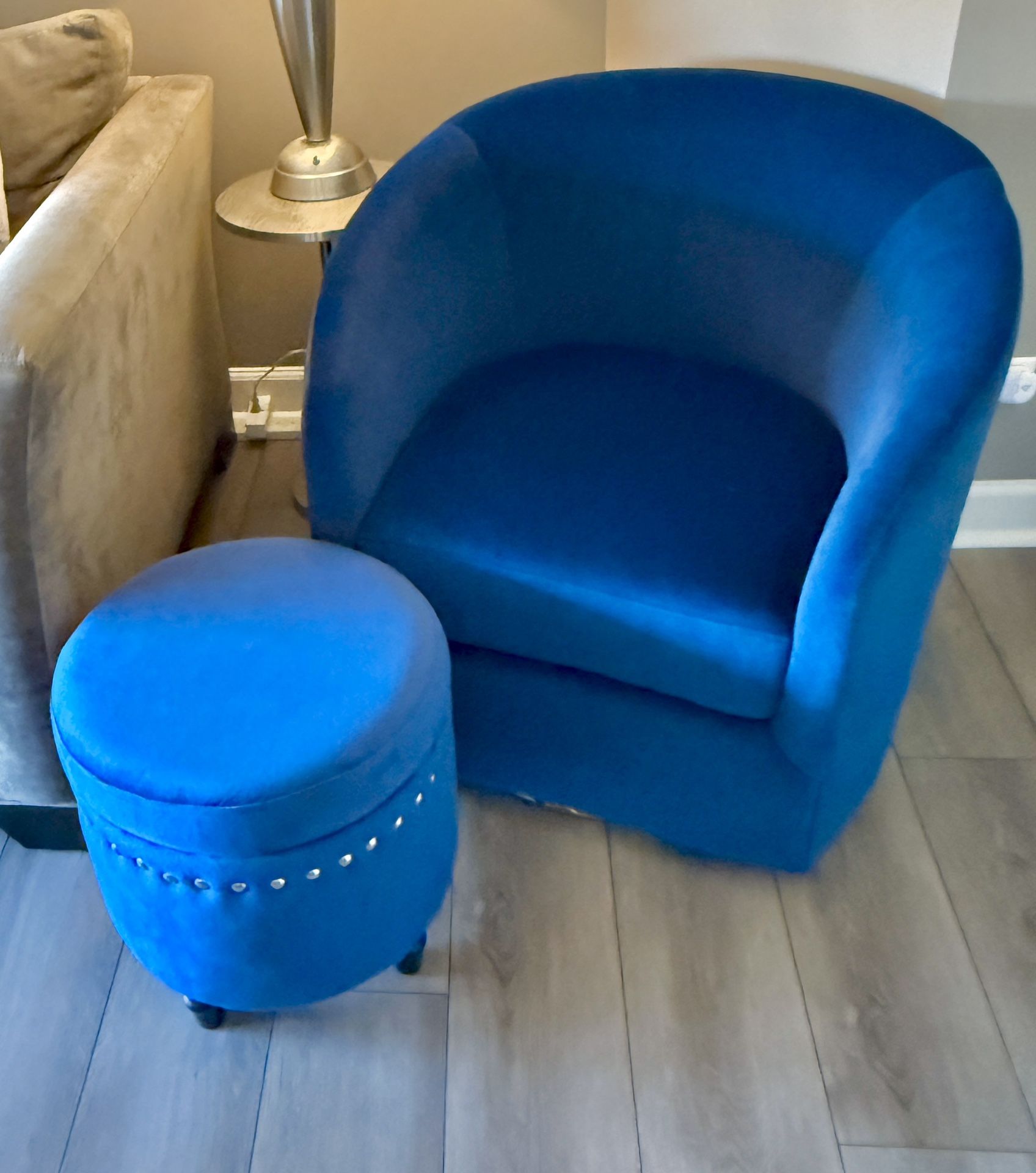 Navy Comfy Velvet Swivel Barrel Chair with Metal Base and 1 matching ottoman.   - Swivel base enables easy mobility - Crafted with solid and