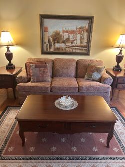 Sofa with brocade fabric and three cushions