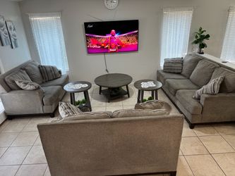 Two love seats and one couch with table set