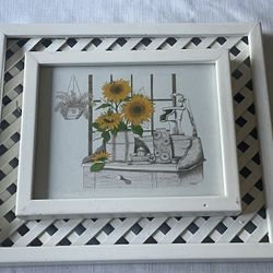 Framed print of sunflowers and a still life with a lattice overlay. 15”x 13”