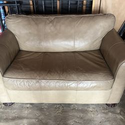 Tan-colored Vinyl steeper loveseat 
