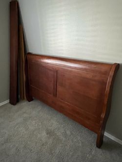 Queen solid wood sleigh bed, mattress and box spring.
